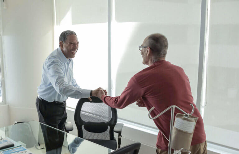 Dr. Tony shaking hands with a patient