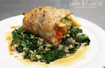 Veggie Stuffed Snapper over a bed of greens